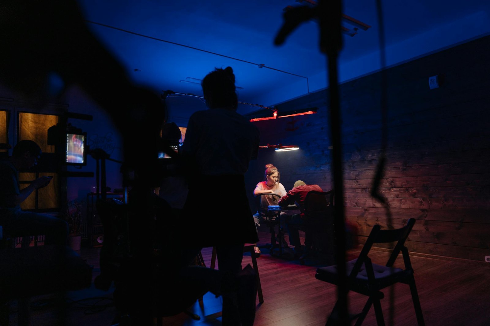 Silhouette of People Standing on Wooden Floor during Night Time